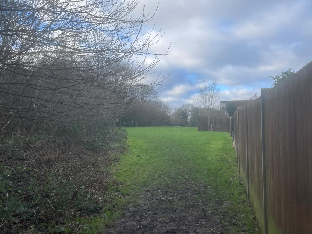 Lot: 9 - TWO FREEHOLD PARCELS OF LAND - View of land from Fowey Close (Entrance End)